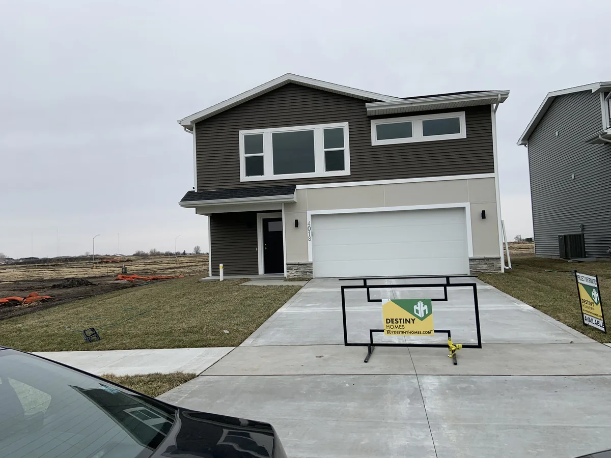 Dark gray siding and white garage on a two-story home