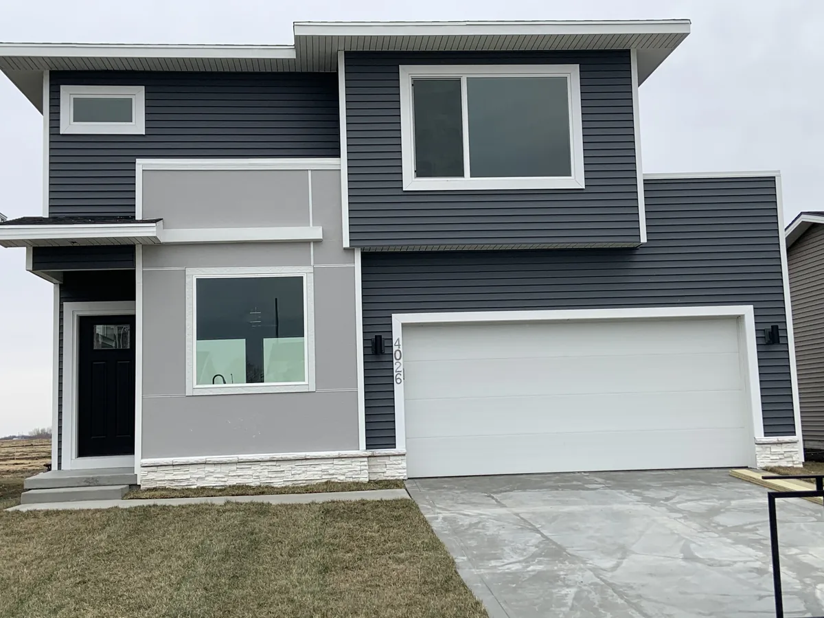 Gray two-tone siding on a two-story home with garage